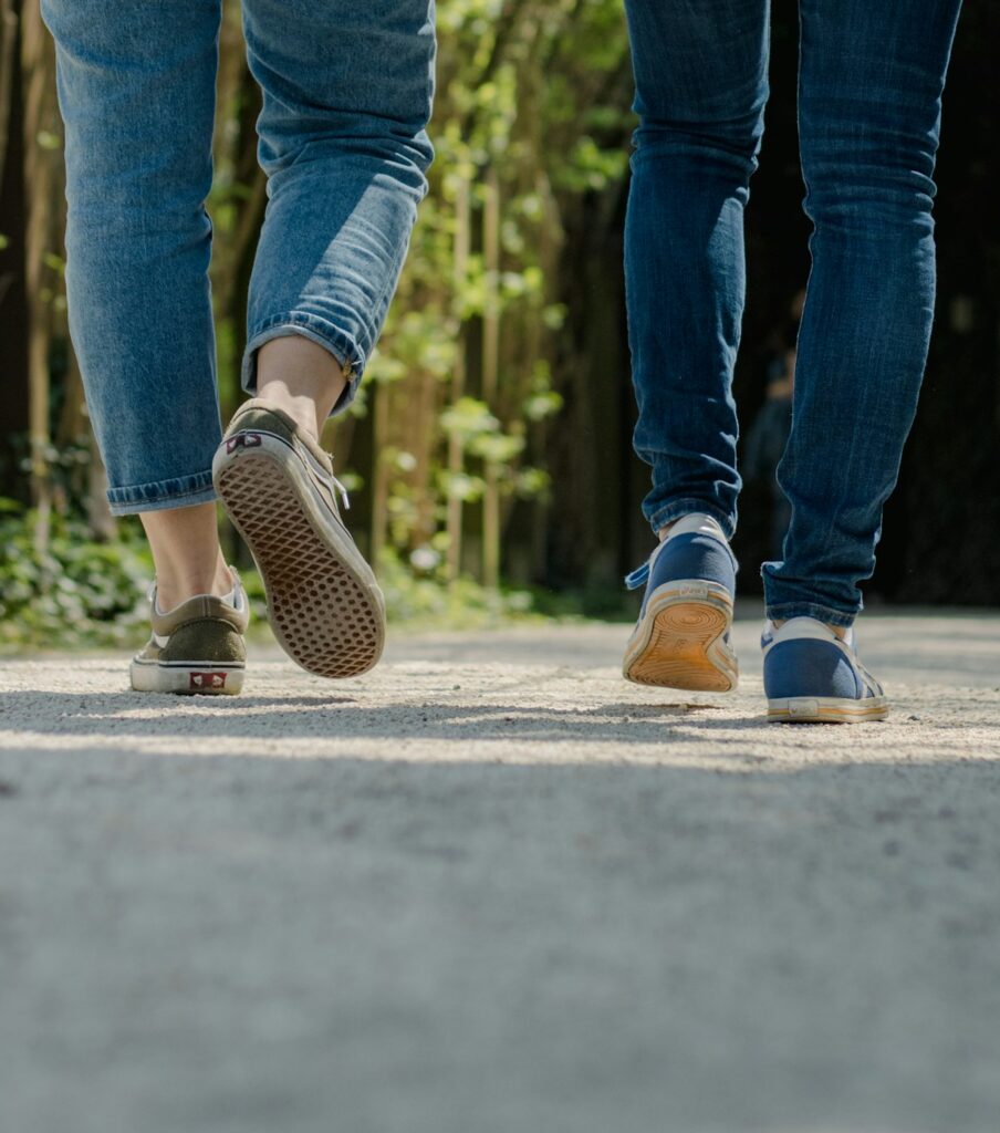 two people walking away from the camera wearing jeans and sneakers on a free guided walking tour in corvallis oregon