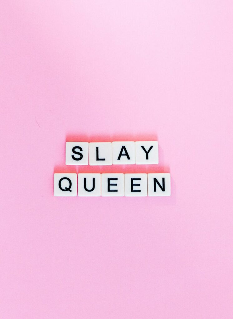 scrabble letters spell out "slay queen" on pink background to represent her corvallis legacy - a storytelling event about women's corvallis history - one of many things to do in corvallis oregon.